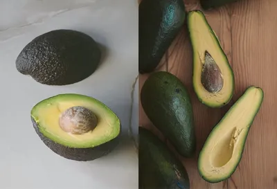 Avocados, whole and halved with seed, arranged on light surface and wooden board.