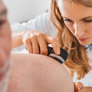 Medical professional using a handheld ultrasound probe on a patient’s shoulder.