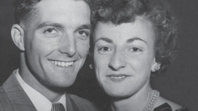 Black-and-white portrait of a smiling couple posing closely, one on the left and the other on the right.