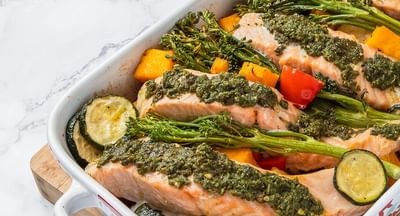A salmon tray bake featuring Mediterranean flavours like zucchini, capsicum and broccolini