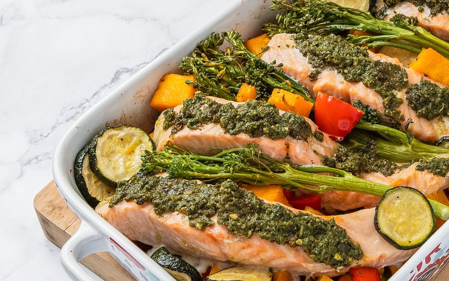 A salmon tray bake featuring Mediterranean flavours like zucchini, capsicum and broccolini