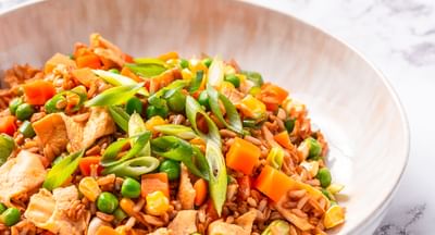 A bowl of fried rice on a marble background