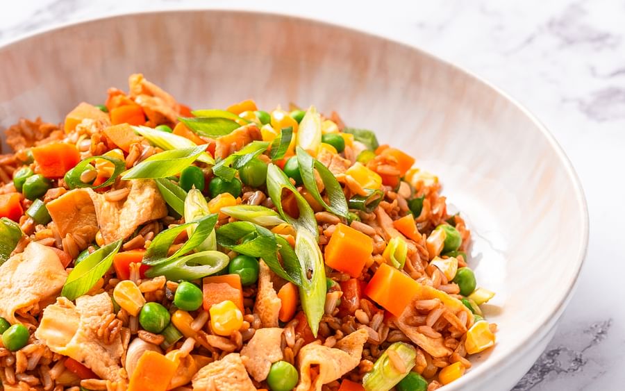 A bowl of fried rice on a marble background