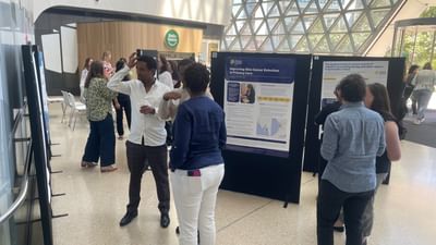 A group of people in the foyer of the Research Symposium.