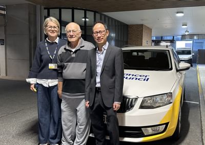 A woman and two men stand in front of a Cancer Council SA vehicle