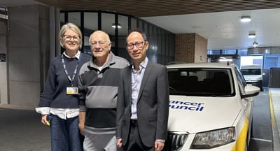 A woman and two men stand in front of a Cancer Council SA vehicle