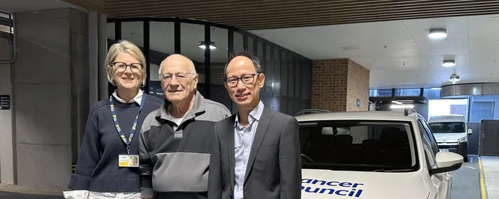 A woman and two men stand in front of a Cancer Council SA vehicle