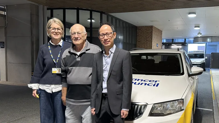 A woman and two men stand in front of a Cancer Council SA vehicle