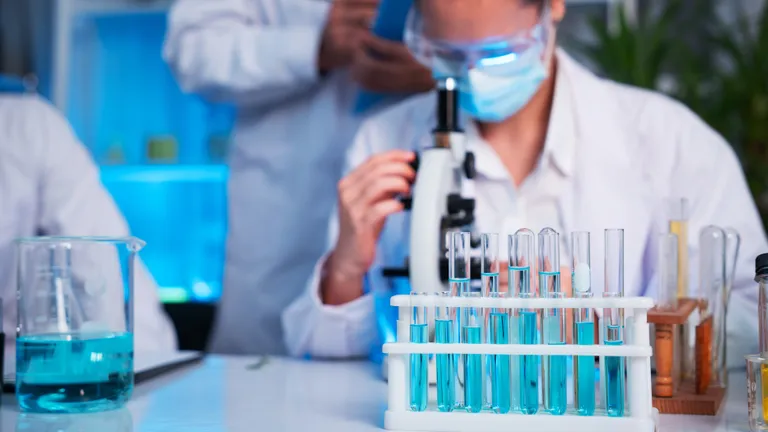 A group of young scientists are conducting experiments in the lab using a microscope (iStock).
