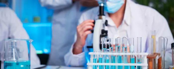 A group of young scientists are conducting experiments in the lab using a microscope (iStock).